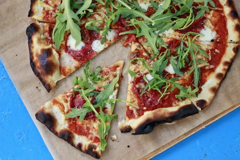 Vibrant pizza slice being pulled apart